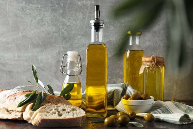 bottles-of-olive-oil-olives-and-slices-of-bread-