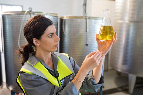 female-technician-examining-olive-oil-02